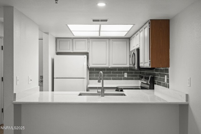 3095 Lakeside Unit 203, Reno, NV 89509 - kitchen featuring freestanding refrigerator, electric range oven, stainless steel microwave, and a peninsula