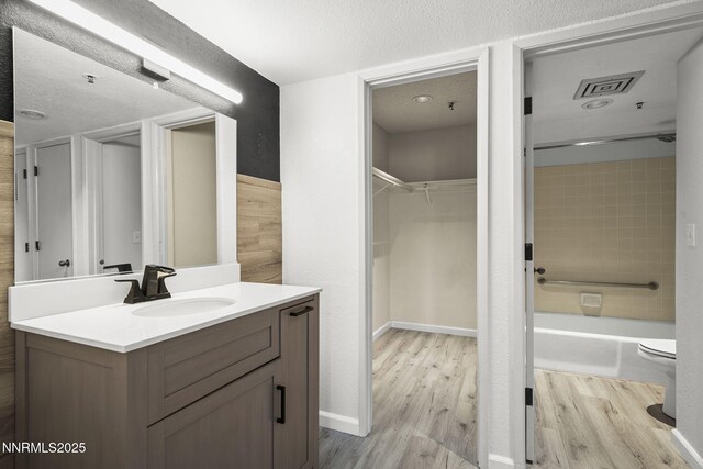 3095 Lakeside Unit 203, Reno, NV 89509 - full bathroom featuring vanity, wood finished floors, shower / bathtub combination, and a spacious closet