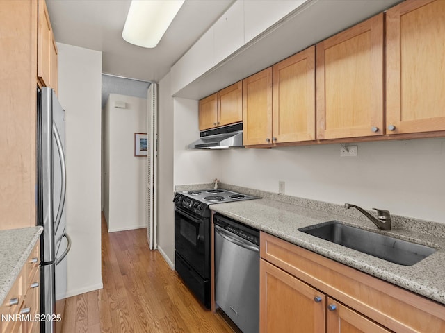 100 N Arlington Ave Unit 20J, Reno, NV 89501 - kitchen featuring under cabinet range hood, stainless steel appliances, light wood-style flooring, and light stone countertops