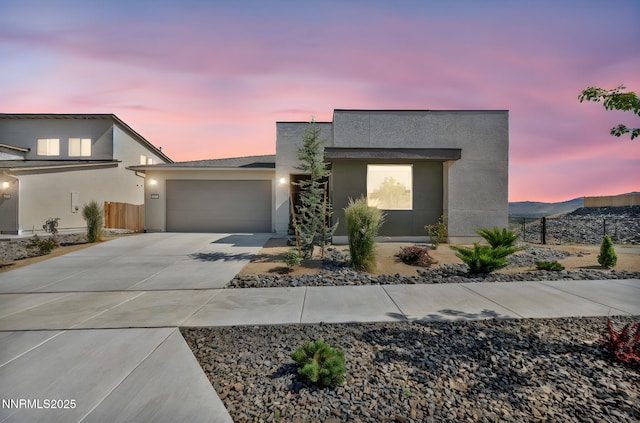 1250 Hubble Ln, Carson City, NV 89705 - contemporary house featuring stucco siding, concrete driveway, and an attached garage