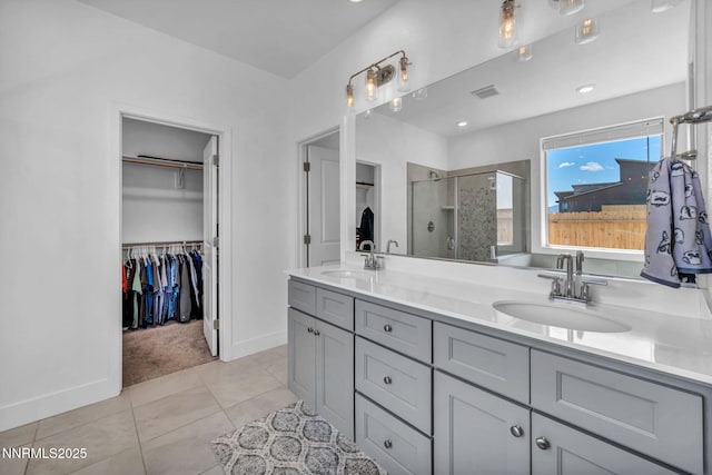1250 Hubble Ln, Carson City, NV 89705 - bathroom with a stall shower, a spacious closet, double vanity, and tile patterned floors