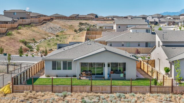 1250 Hubble Ln, Carson City, NV 89705 - back of house with stucco siding, a residential view, a fenced backyard, a patio area, and roof with shingles