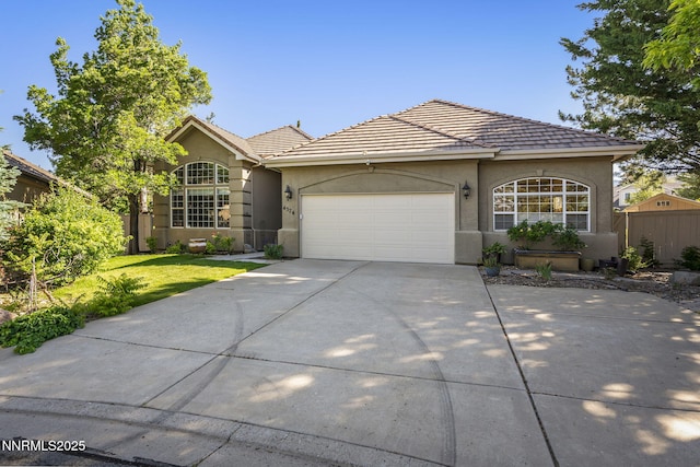 4374 Cullen Ct, Reno, NV 89519 - view of front of house with driveway, stucco siding, a garage, a front lawn, and a tile roof