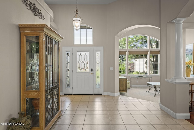 4374 Cullen Ct, Reno, NV 89519 - foyer entrance with decorative columns, light tile patterned floors, a towering ceiling, a chandelier, and arched walkways