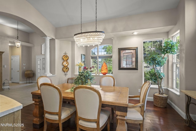 4374 Cullen Ct, Reno, NV 89519 - dining area with ornate columns, arched walkways, dark wood-style floors, and a chandelier