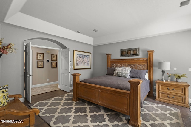 4374 Cullen Ct, Reno, NV 89519 - bedroom with arched walkways, wood finished floors, and a tray ceiling