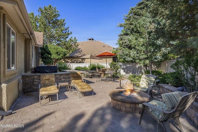 4374 Cullen Ct, Reno, NV 89519 - fenced backyard featuring a patio and a fire pit