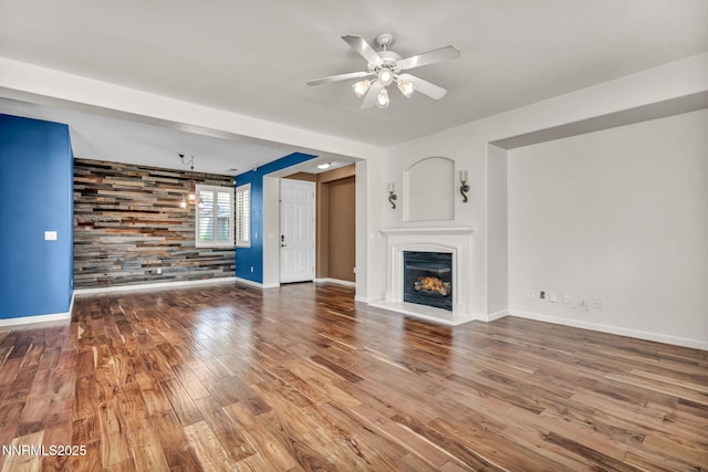 6469 Hale Bopp Ct, Sparks, NV 89436 - unfurnished living room featuring wood finished floors, ceiling fan, and a warm lit fireplace