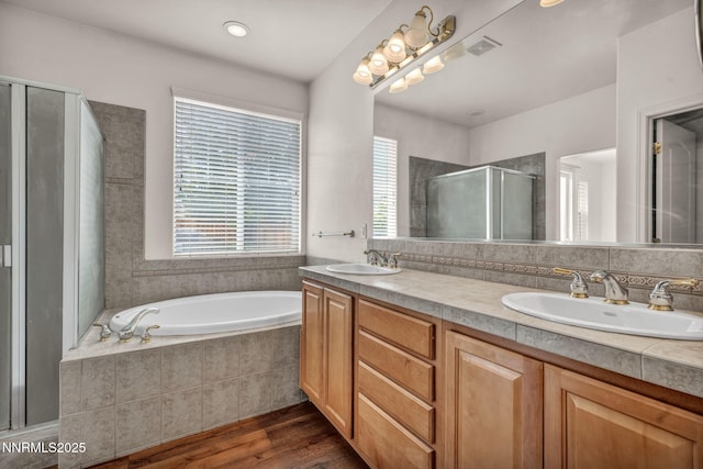 6469 Hale Bopp Ct, Sparks, NV 89436 - bathroom featuring a stall shower, double vanity, wood finished floors, and a bath