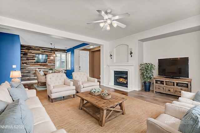 6469 Hale Bopp Ct, Sparks, NV 89436 - living area featuring a ceiling fan, light wood-type flooring, and a glass covered fireplace