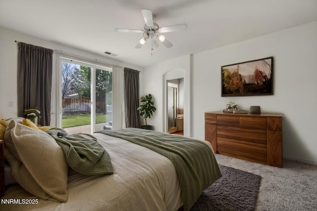 6469 Hale Bopp Ct, Sparks, NV 89436 - carpeted bedroom featuring access to exterior, arched walkways, ensuite bath, and ceiling fan