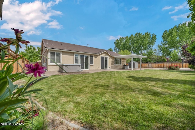 6469 Hale Bopp Ct, Sparks, NV 89436 - back of property with a patio area, a hot tub, stucco siding, and a fenced backyard