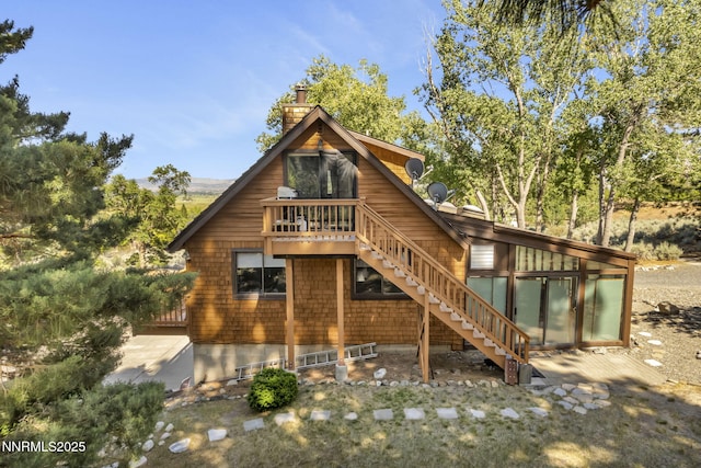 187 Jeannie Ln, Gardnerville, NV 89460 - view of front of house with stairs, a chimney, and a wooden deck