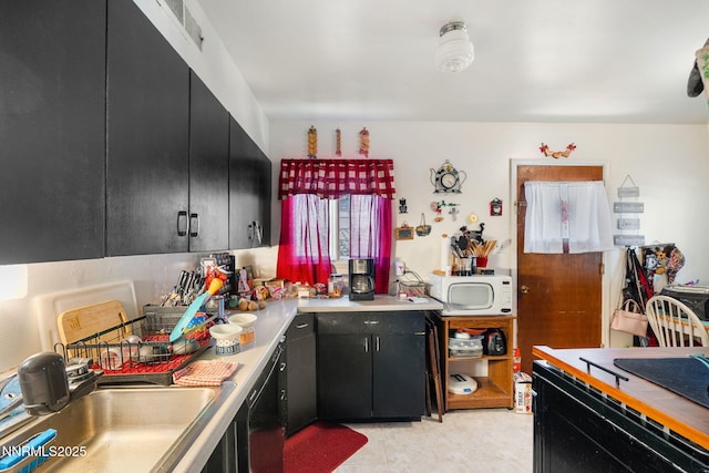 2455 Coppa Way, Sparks, NV 89431 - kitchen featuring dark cabinets, white microwave, and light countertops