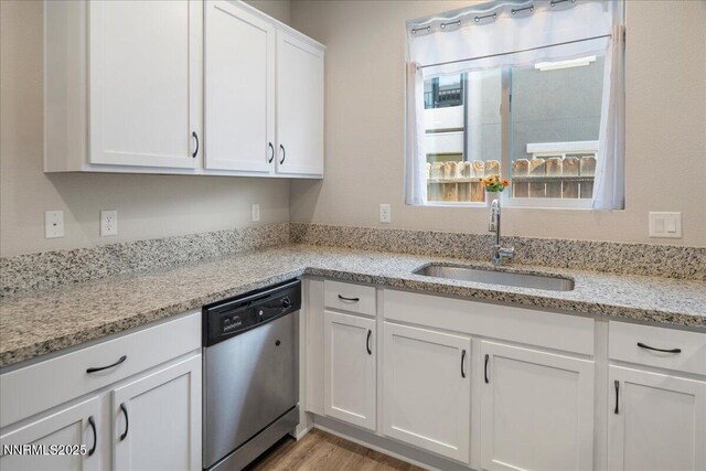 2170 Santona Cir, Reno, NV 89523 - kitchen with dishwasher, white cabinets, light stone counters, and light wood-style floors