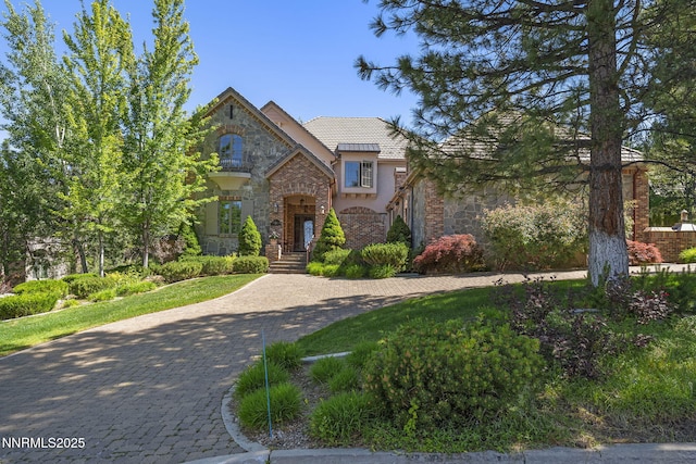 5830 Strasbourg Ct, Reno, NV 89511 - french country style house with stone siding, stucco siding, and curved driveway