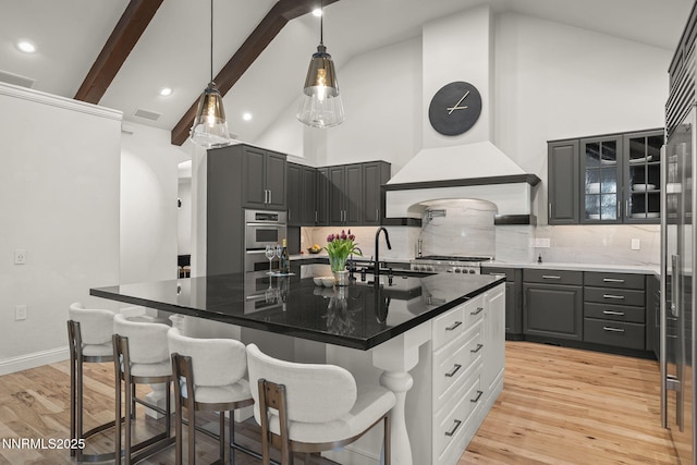 5830 Strasbourg Ct, Reno, NV 89511 - kitchen with high vaulted ceiling, decorative backsplash, double oven, a kitchen breakfast bar, and premium range hood