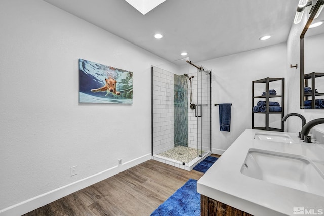3430 Gwynelle Ct, Sparks, NV 89431 - bathroom with a stall shower, double vanity, wood finished floors, recessed lighting, and a skylight