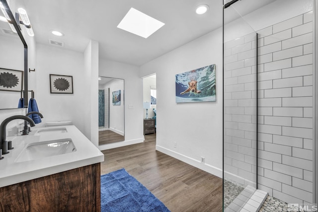 3430 Gwynelle Ct, Sparks, NV 89431 - bathroom with a skylight, double vanity, wood finished floors, a walk in shower, and recessed lighting