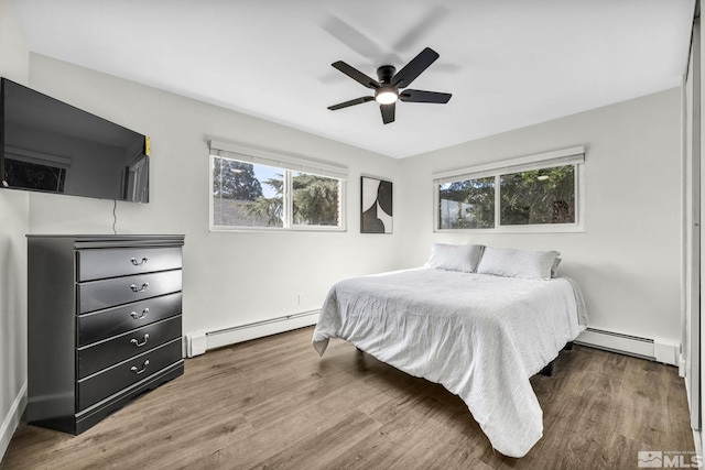 3430 Gwynelle Ct, Sparks, NV 89431 - bedroom featuring a baseboard radiator, wood finished floors, and ceiling fan