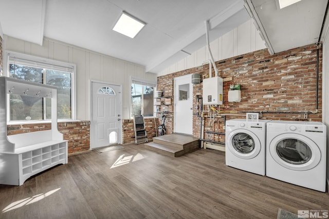 3430 Gwynelle Ct, Sparks, NV 89431 - washroom with brick wall, washer and clothes dryer, wood finished floors, and plenty of natural light