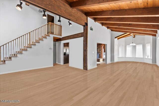 650 Tumbleweed Cir, Incline Village, NV 89451 - unfurnished living room with wood finished floors, stairs, high vaulted ceiling, a wooden ceiling with exposed beams, and track lighting