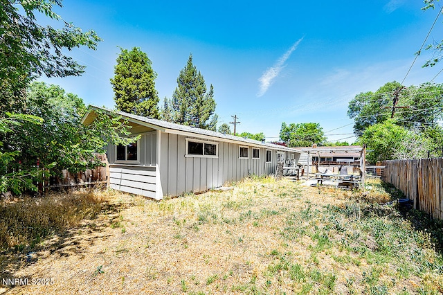 1009 E Robinson St, Carson City, NV 89701 - rear view of property with board and batten siding and a fenced backyard