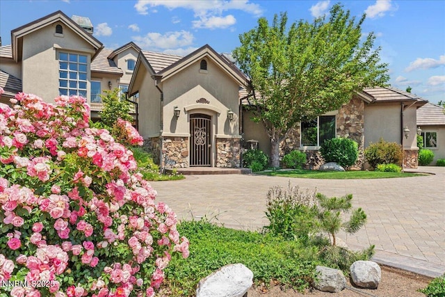 2550 Old Waverly Ct, Sparks, NV 89436 - view of front of house with stone siding, stucco siding, and a tile roof
