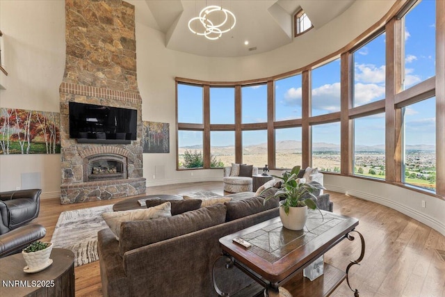2550 Old Waverly Ct, Sparks, NV 89436 - living area featuring a fireplace, a high ceiling, and wood finished floors