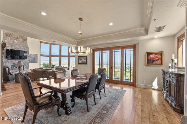 2550 Old Waverly Ct, Sparks, NV 89436 - dining area featuring crown molding, a raised ceiling, healthy amount of natural light, light wood finished floors, and a chandelier