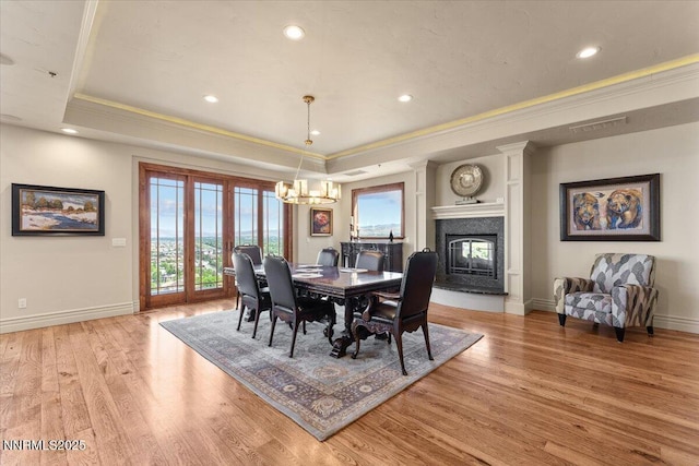 2550 Old Waverly Ct, Sparks, NV 89436 - dining area featuring ornamental molding, a raised ceiling, a fireplace, light wood finished floors, and recessed lighting