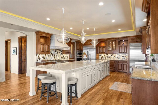 2550 Old Waverly Ct, Sparks, NV 89436 - kitchen featuring appliances with stainless steel finishes, tasteful backsplash, a spacious island, open shelves, and recessed lighting
