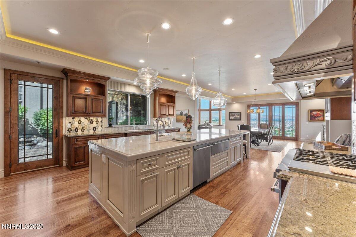 2550 Old Waverly Ct, Sparks, NV 89436 - kitchen with premium range hood, ornamental molding, dishwasher, an island with sink, and open shelves