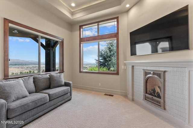 2550 Old Waverly Ct, Sparks, NV 89436 - carpeted living area with healthy amount of natural light, a fireplace, a tray ceiling, and recessed lighting