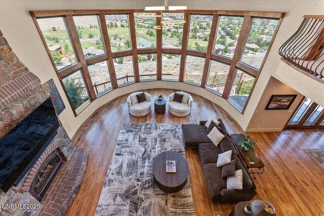 2550 Old Waverly Ct, Sparks, NV 89436 - sunken living room featuring a fireplace, wood finished floors, and a high ceiling