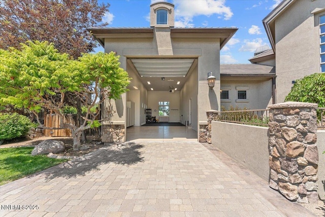 2550 Old Waverly Ct, Sparks, NV 89436 - view of exterior entry with decorative driveway, stucco siding, and a chimney