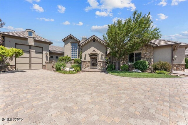 2550 Old Waverly Ct, Sparks, NV 89436 - view of front of house with stone siding, decorative driveway, stucco siding, and an attached garage