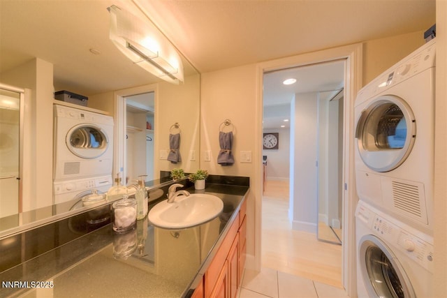 450 N Arlington Ave Unit 715, Reno, NV 89503 - bathroom featuring stacked washing machine and dryer, vanity, and tile patterned floors