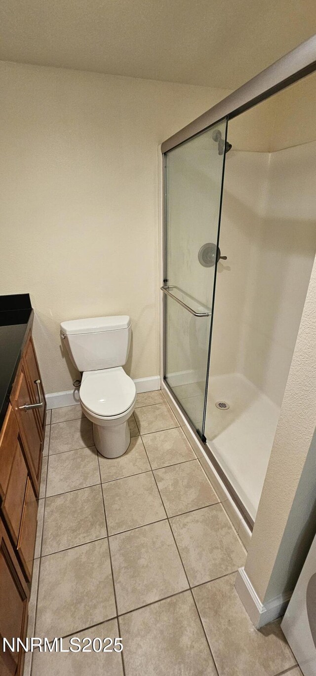 450 N Arlington Ave Unit 715, Reno, NV 89503 - bathroom featuring a shower stall, vanity, and tile patterned flooring