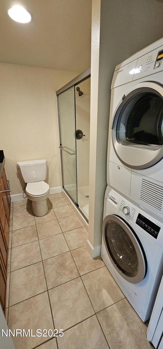450 N Arlington Ave Unit 715, Reno, NV 89503 - laundry area featuring estacked washer and dryer and light tile patterned flooring