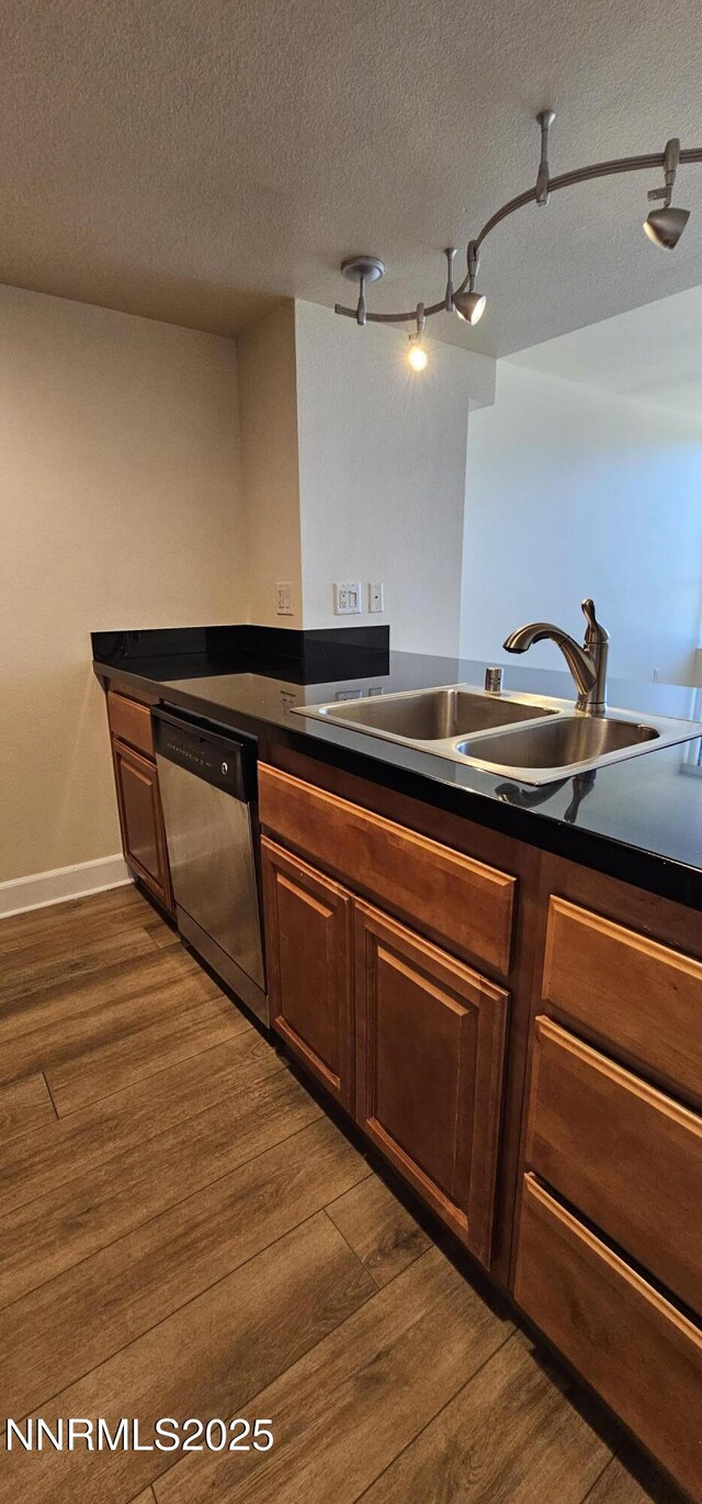 450 N Arlington Ave Unit 715, Reno, NV 89503 - kitchen featuring stainless steel dishwasher, dark wood finished floors, dark countertops, and a textured ceiling