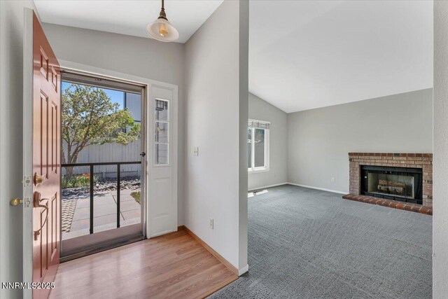 971 Shadow Ln, Carson City, NV 89705 - entryway with lofted ceiling, plenty of natural light, carpet floors, and a brick fireplace