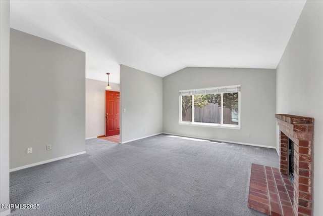 971 Shadow Ln, Carson City, NV 89705 - unfurnished living room with carpet floors, vaulted ceiling, and a brick fireplace
