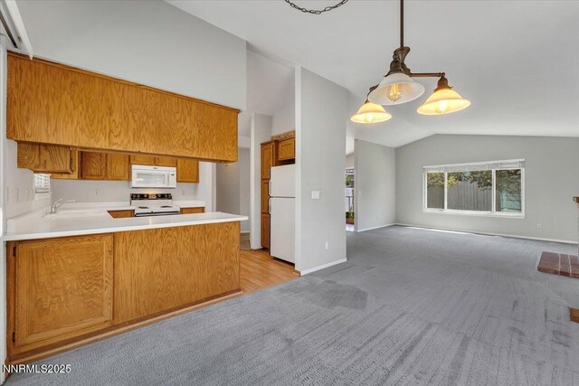 971 Shadow Ln, Carson City, NV 89705 - kitchen featuring white appliances, vaulted ceiling, open floor plan, light colored carpet, and brown cabinetry