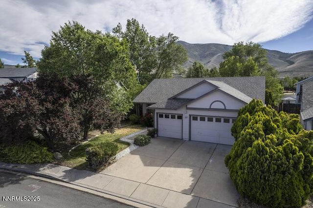 8589 Turtle Creek Ct, Reno, NV 89506 - view of front of home featuring an attached garage, driveway, and a mountain view