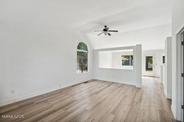 8589 Turtle Creek Ct, Reno, NV 89506 - unfurnished living room with ceiling fan, light wood-type flooring, and vaulted ceiling