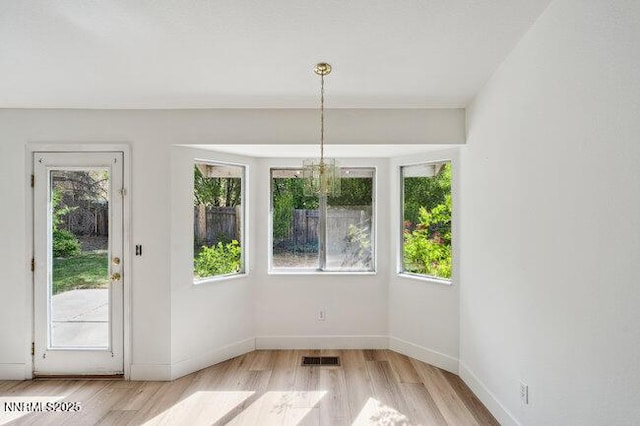 8589 Turtle Creek Ct, Reno, NV 89506 - unfurnished dining area featuring wood finished floors and a chandelier