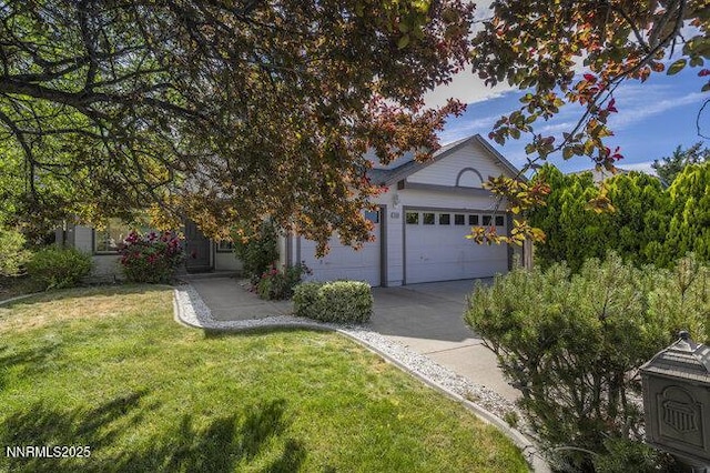 8589 Turtle Creek Ct, Reno, NV 89506 - view of property hidden behind natural elements with concrete driveway, an attached garage, and a front lawn