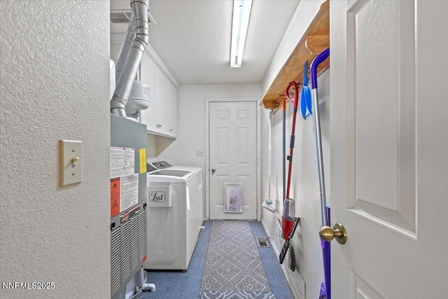 1510 E Slide Mountain Dr, Carson City, NV 89706 - washroom featuring washing machine and clothes dryer, water heater, cabinet space, and a textured wall
