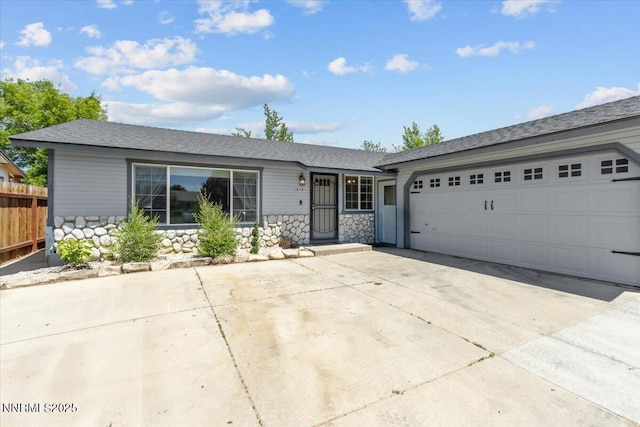 1510 E Slide Mountain Dr, Carson City, NV 89706 - ranch-style home with stone siding, concrete driveway, and a garage